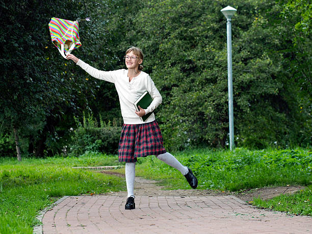 istock Happy school girl in the park 602304810