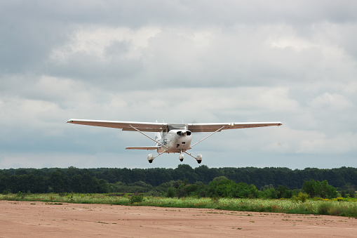 Zhitomir, Ukraine - July 31, 2011: Cessna 172S Skyhawk XP is taking off from runway into cloudy sky for a leisure flight