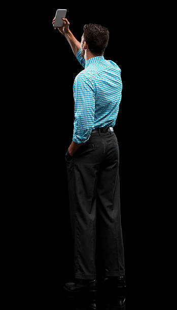 istock Rear view of businessman taking a selfie 602305674