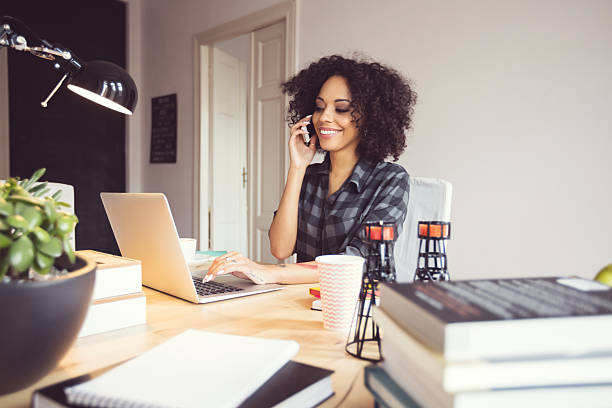 istock Afro young woman in the home office, using laptop 602307256