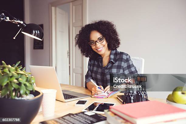 Afro Young Woman In The Home Office Using Laptop Stock Photo - Download Image Now - Home Office, Working At Home, African Ethnicity