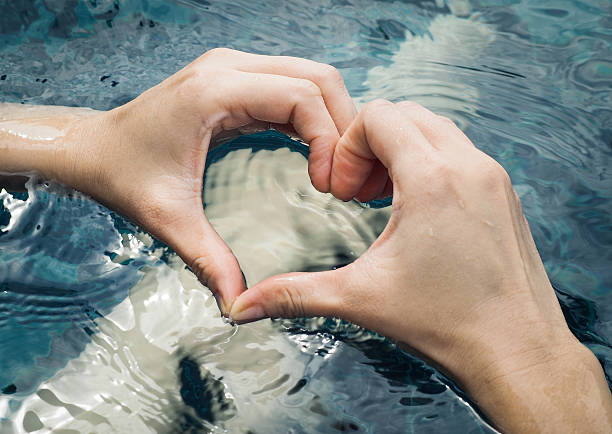 istock Heart from hands on swimming pool 602308062