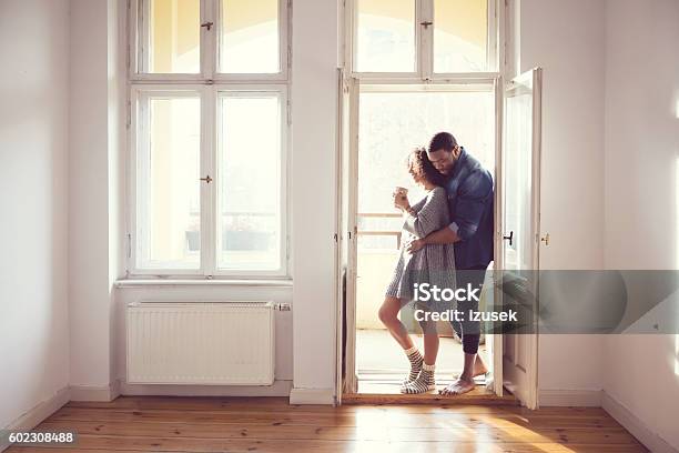 Afro American Couple Standing By The Window At Home Stock Photo - Download Image Now