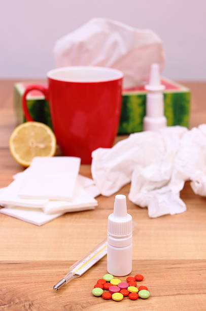 istock Pills and nose drops for colds, used handkerchiefs, hot tea 602310506