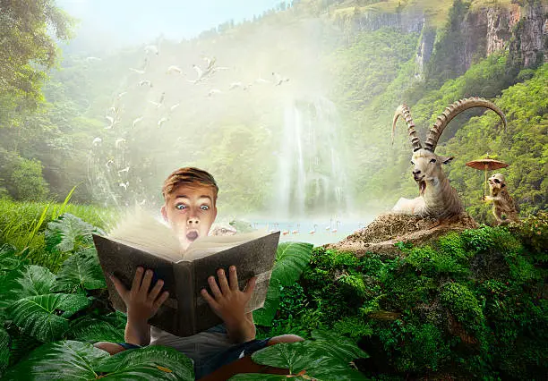 Boy reading a wonderful fairy story. Concept of reading books for children
