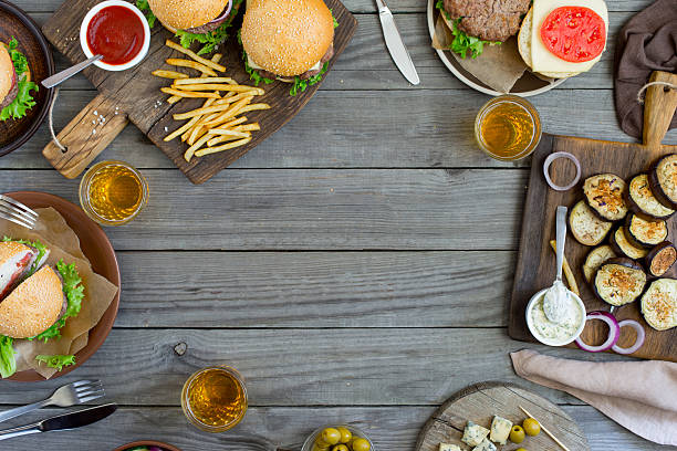 istock Frame from different burgers and snacks on wooden table 602316486
