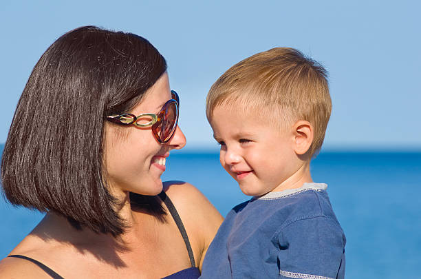 istock smiling mother and son looking at each other 602318132