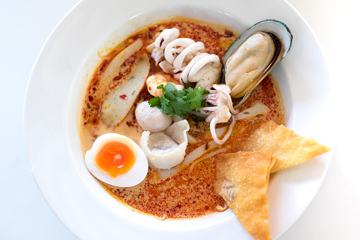 Tom Yam sea food noodle on white table (Thai cuisine)