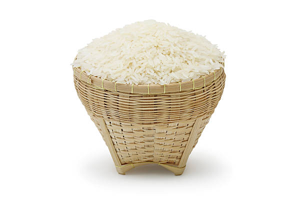 Thai jasmine rice Thai jasmine rice in the basket weave isolate on white background basket healthy eating vegetarian food studio shot stock pictures, royalty-free photos & images