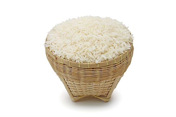 Thai jasmine rice Thai jasmine rice in the basket weave isolate on white background basket healthy eating vegetarian food studio shot stock pictures, royalty-free photos & images