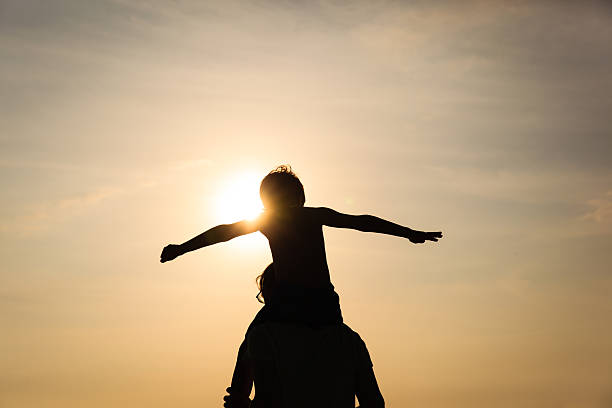 istock father and son play on sunset sky 602319010