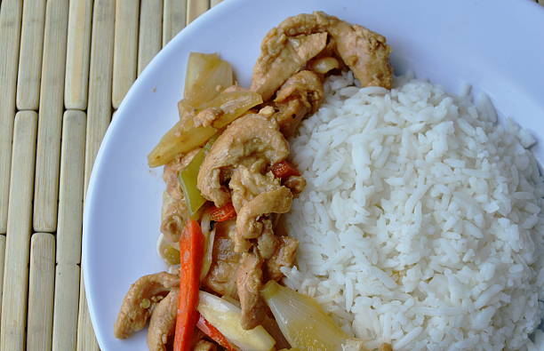 istock stir fried chicken with long sweet chili on plain rice 602319030