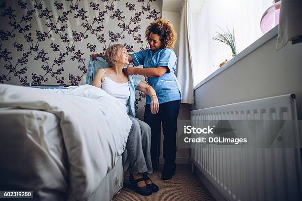 Home Caregiver Dressing Senior Stock Photo - Download Image Now - Nursing Home, Domestic Life, Home Caregiver