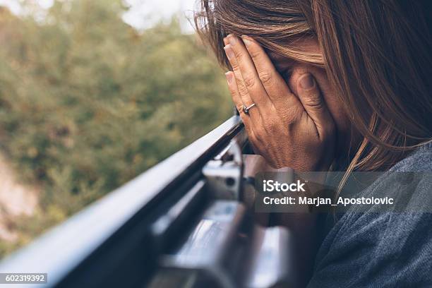 Depressed Young Woman In The Train Stock Photo - Download Image Now - Abuse, Train - Vehicle, Crying