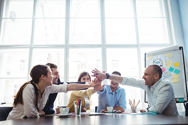 istock Colleagues high-five in meeting room 602320308