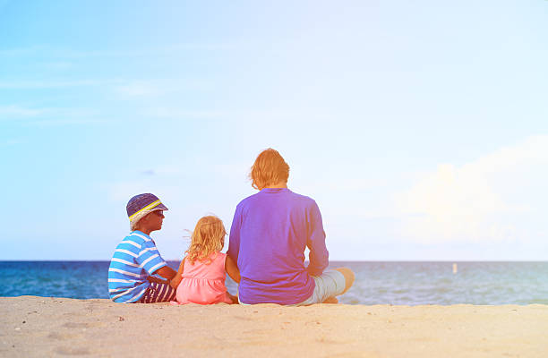 istock father with little son and daughter on beach 602322326