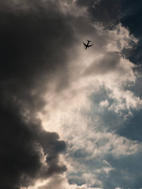 istock Small silhouette of an jetplane against a dramatic sky 602325090