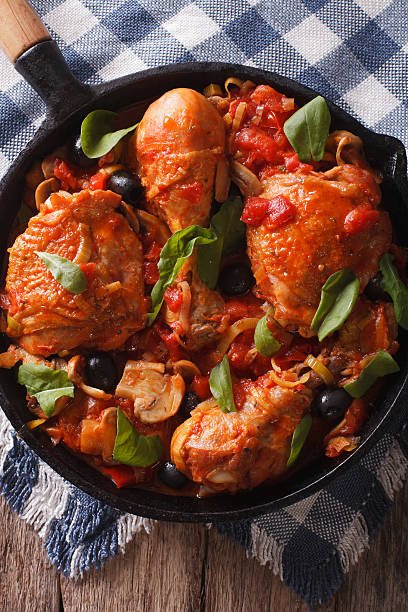 istock Cacciatori Chicken with mushrooms closeup in pan. vertical top view 602325406