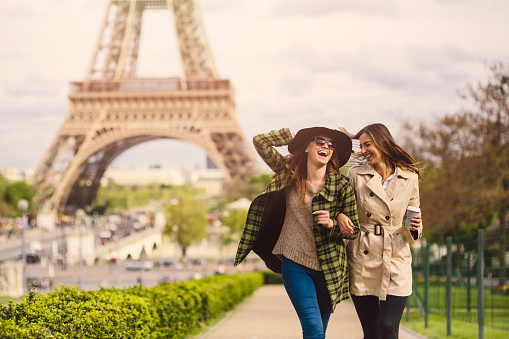 Two friends taking a walk around the Eiffel Tower in Paris.