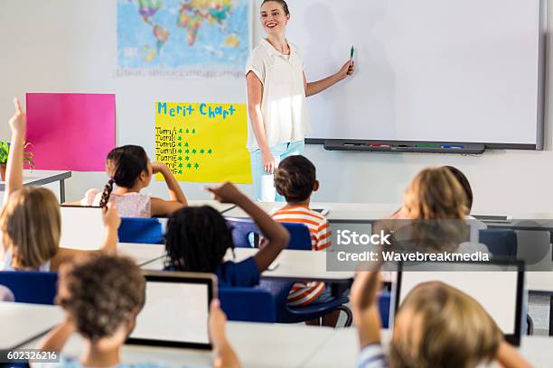Lehrer Unterrichtet Schüler Mit Whiteboard Stockfoto und mehr Bilder von Weiße Tafel - Weiße Tafel, Klassenzimmer, Lehrkraft
