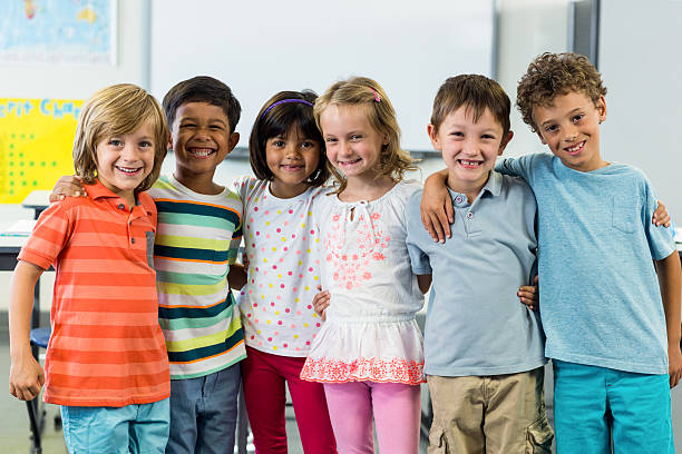 istock Happy schoolchildren standing in classroom 602326376
