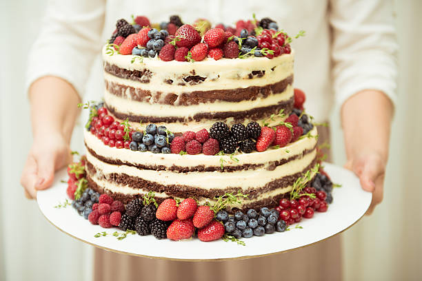 istock Wedding cake in two tiers with fresh berries holding 602326882