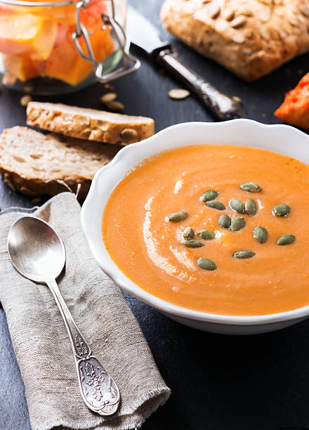 istock Pumpkin soup in a white bowl on table 602327416