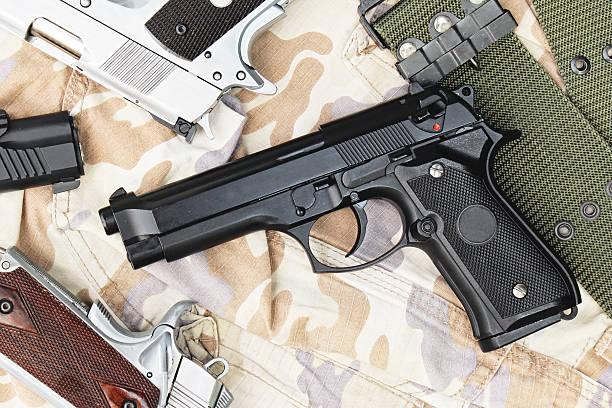 istock Handguns on camouflage background. 9mm Pistols. 602328498