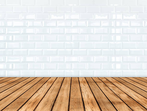 istock Empty wooden plank floor and glossy white tile ceramic wall 602328550