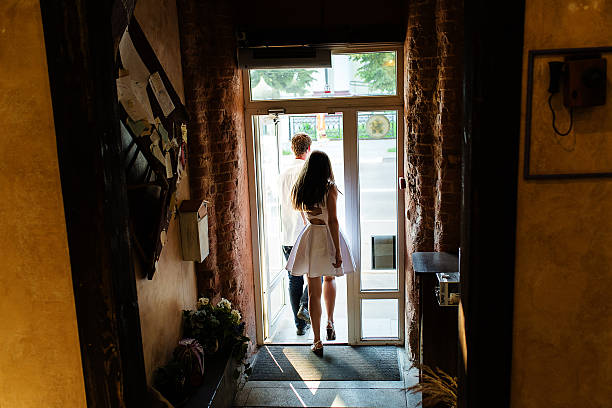 istock couple leaving a cozy cafe through the door 602328668