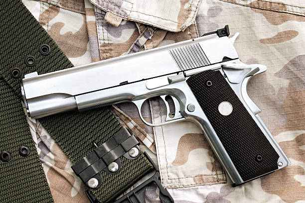 istock Gun on Military texture, .45 pistol. 602328918