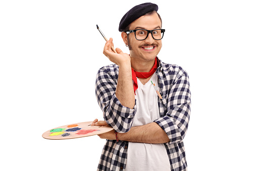 Joyful painter holding a paintbrush and a color palette isolated on white background