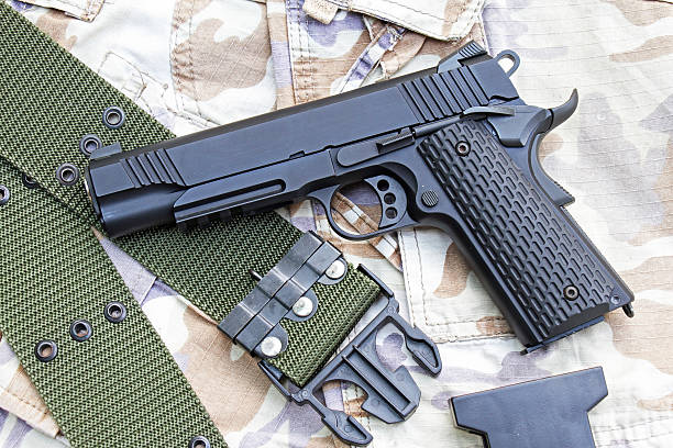 istock Gun on Military texture, .45 pistol. 602329200