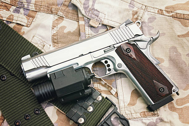 istock Gun on Military texture, .45 pistol. 602329446
