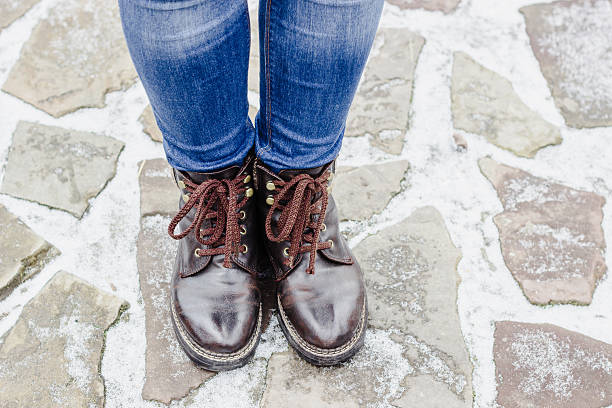 istock High angle view on woman's legs wearing brown shoes 602329614
