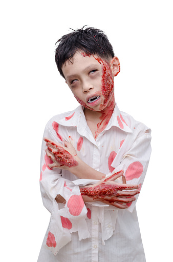 Young asian boy in zombie make up and costume over white