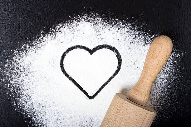 istock Flour and rolling pin with a heart symbol 602330836