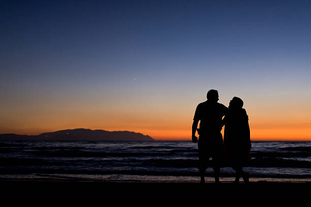 istock Silhouette of a couple on the beach 602331576
