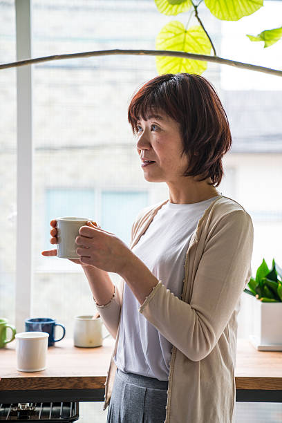 istock Senior woman talking with coffee in the kitchen 602332654