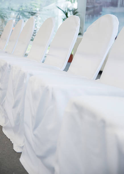 istock chairs with white fabric cover for celebrations 602334260