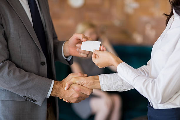 istock Business colleagues exchanging business card 602335428