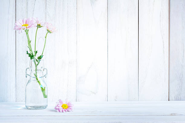 istock daisies in vase on a old wooden table 602336372