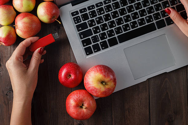 istock Close up of a woman hand plugging  red pendrive 602336602