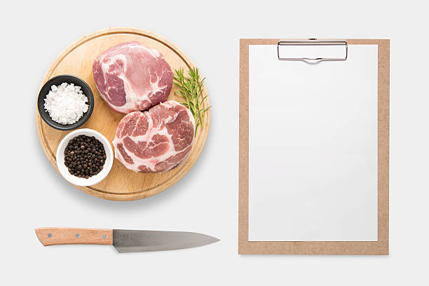 Design concept of mockup clip board and pork isolated. Design concept of mockup clip board and pork on cutting board set isolated on white background. Clipping Path included isolated on white background. beef pad stock pictures, royalty-free photos & images