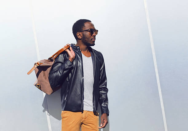Fashion elegant african man with bag in city stock photo
