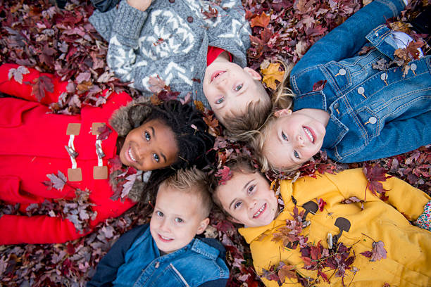 istock Children Lying in a Circle at the Park 603152076