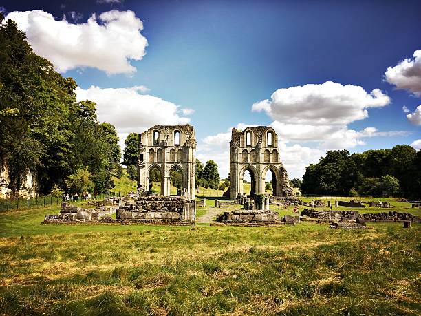 Malty, UK - August 6, 2016: Visitors walking through the ruins of the English Heritage site of Roche Abbey.