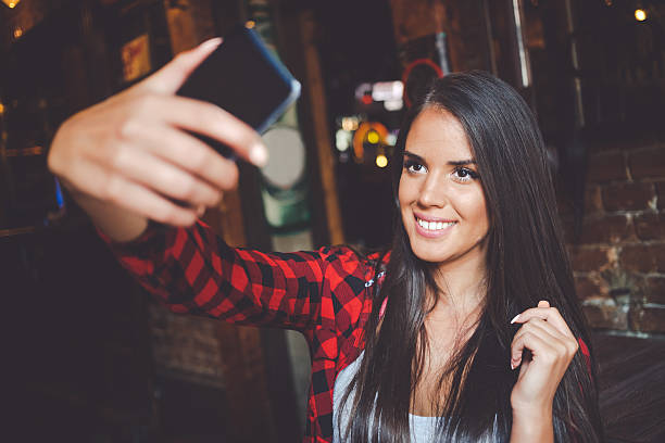 istock Young woman taking selfie in cafe 603153702