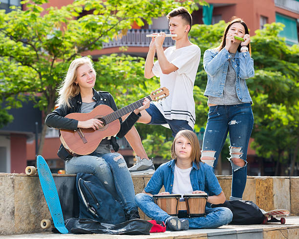 istock Laughing girls and boys with musical instruments 603154240