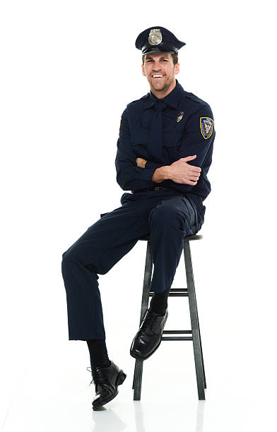 istock Smiling police sitting on stool 603155710